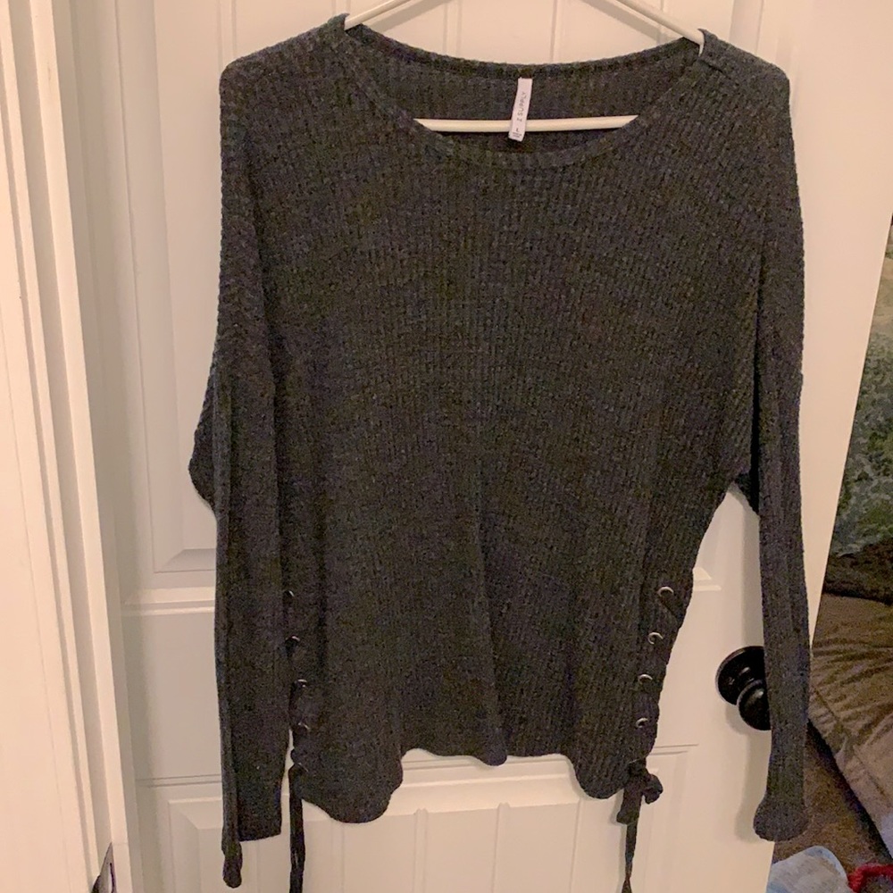Long-sleeved charcoal shirt with ties on the side.